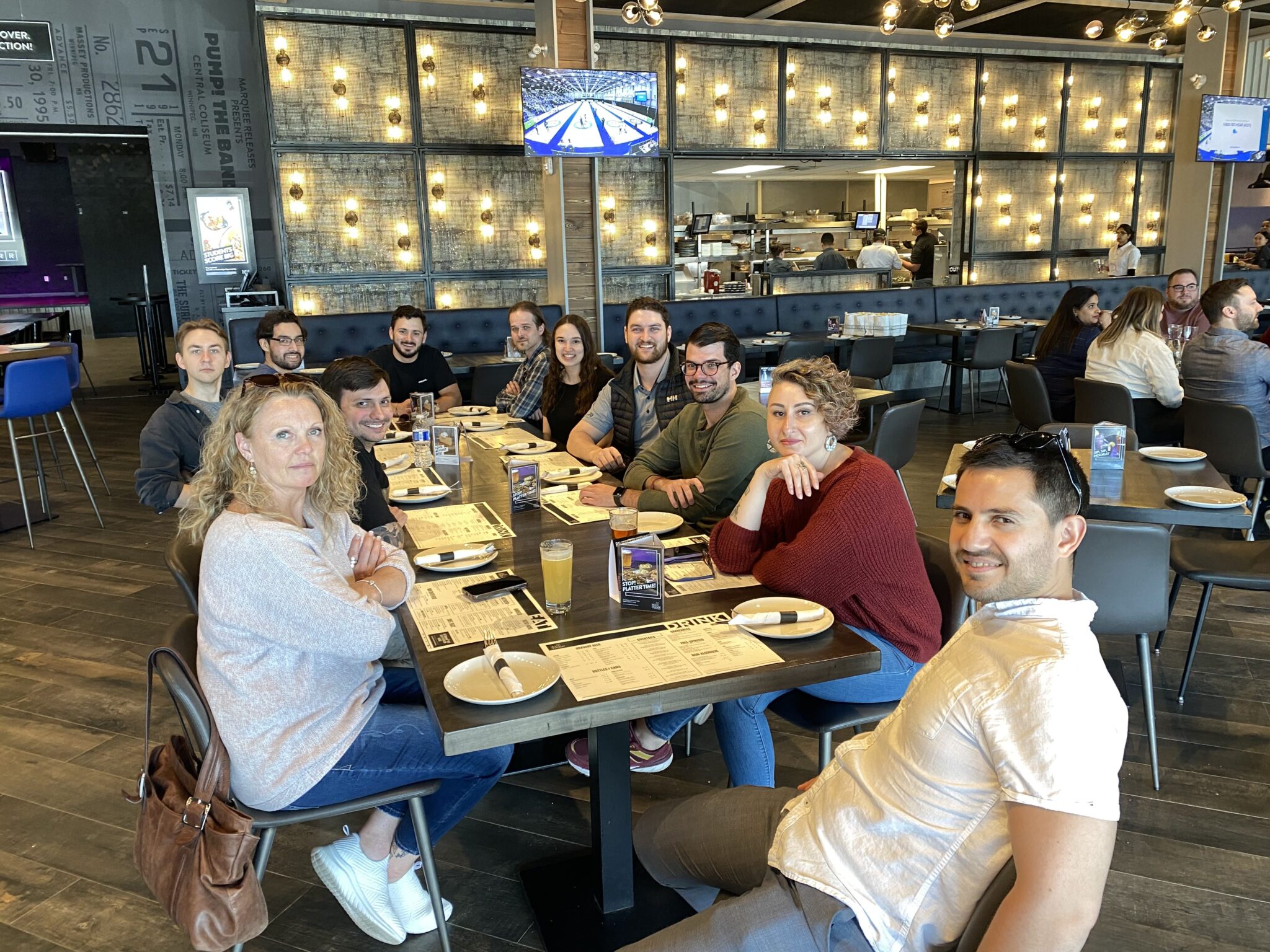 team sitting down for lunch at the rec room