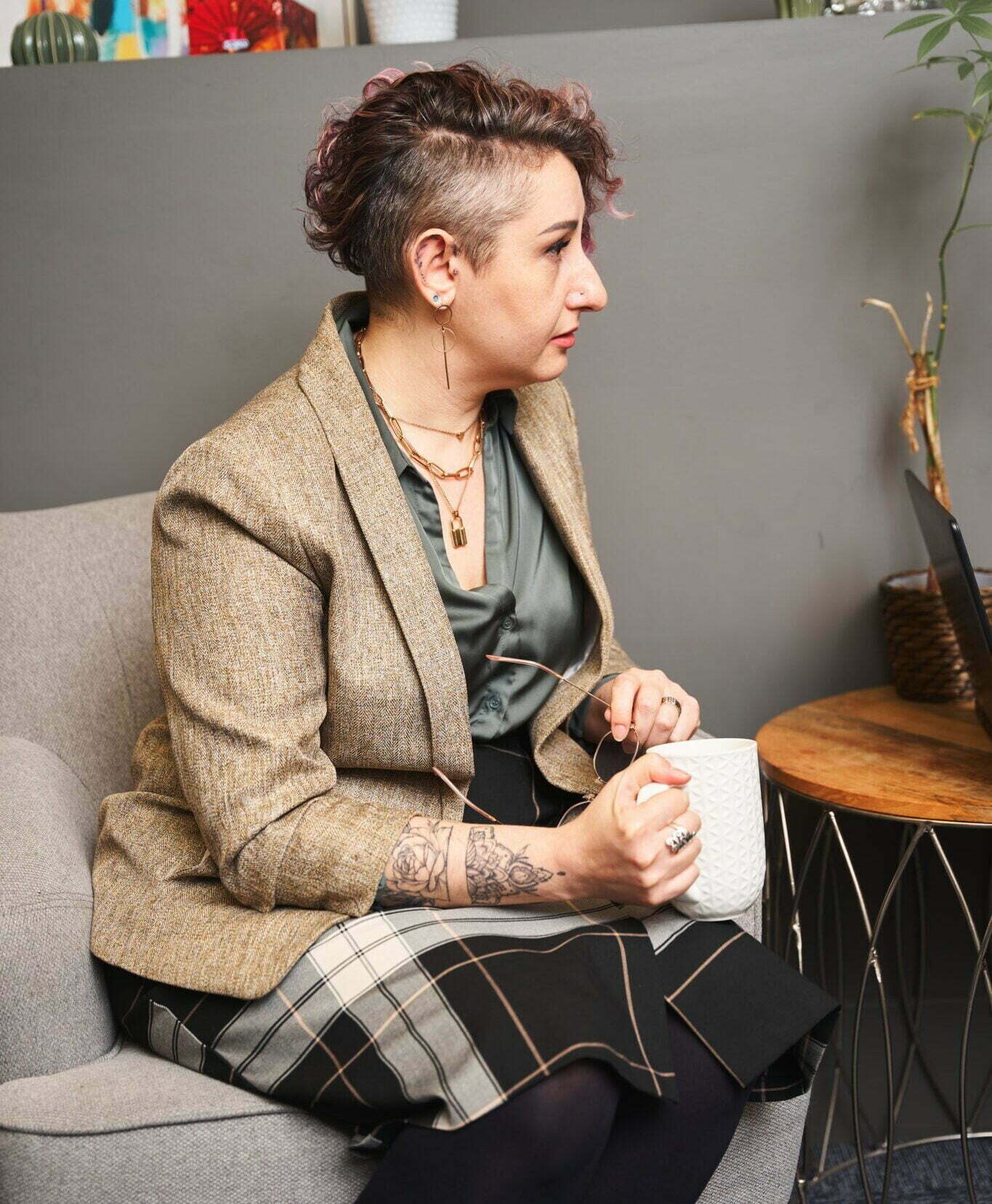 woman sitting on chair holding a cup of coffee