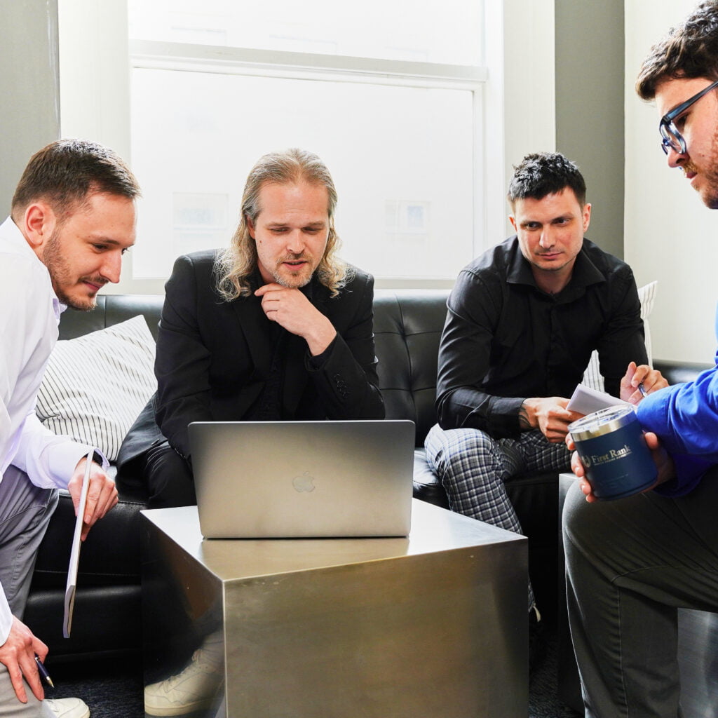 team sitting looking at computer
