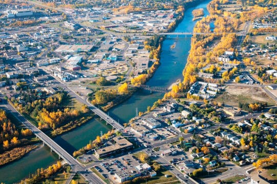 Aerial view of downtown Red Deer, Alberta, with the Red Deer River and surrounding businesses.