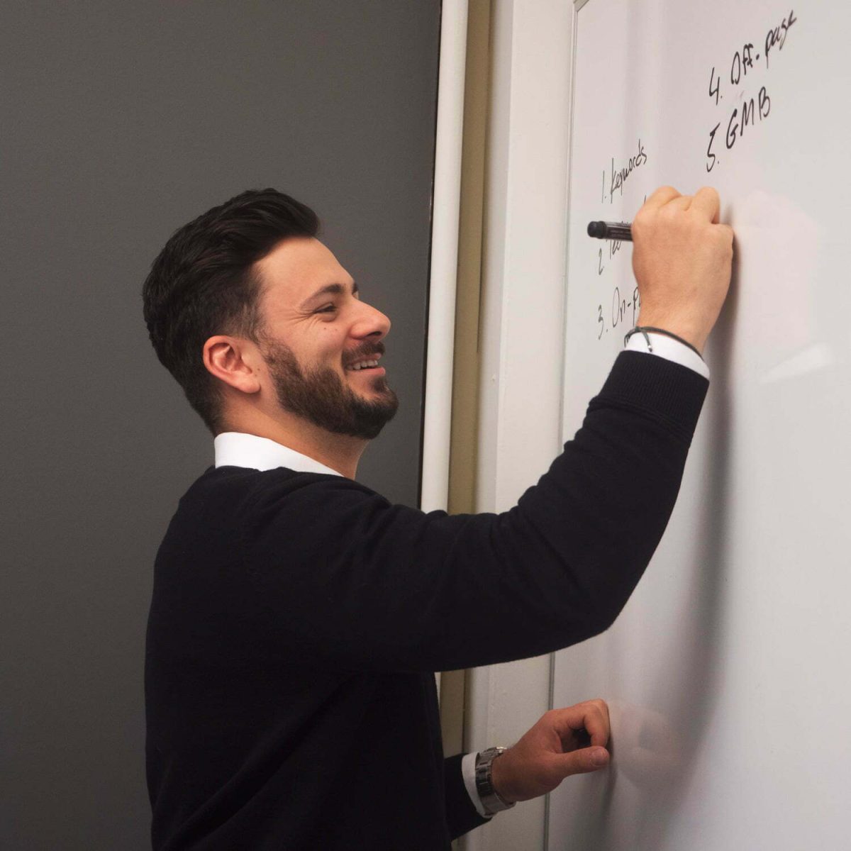 man writing on a white board