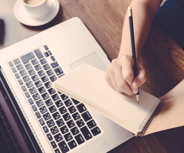 Female writing information on paper in workplace. office concept Female writing information on paper in workplace. office concept